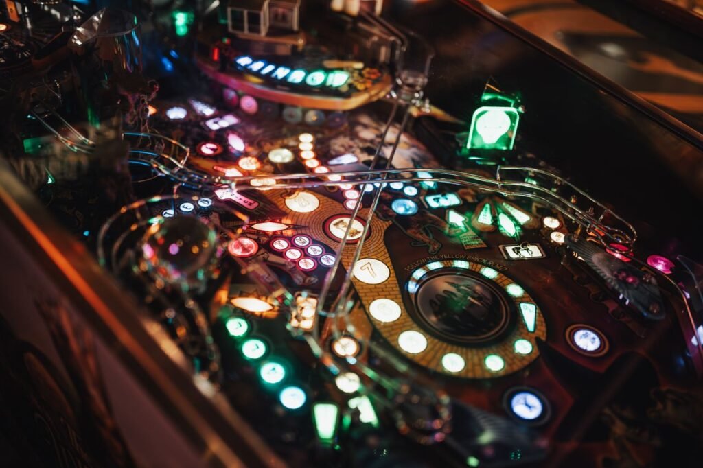 Colorful close-up of an illuminated pinball machine showcasing detailed game mechanics.